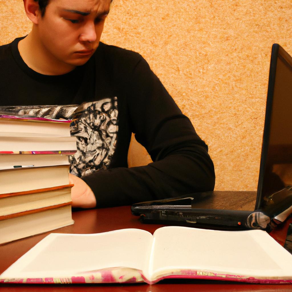 Person studying with textbooks and laptop